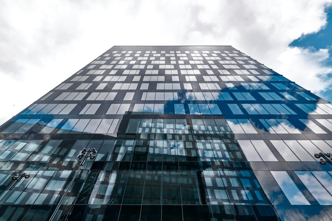 Modern glass office building seen from below